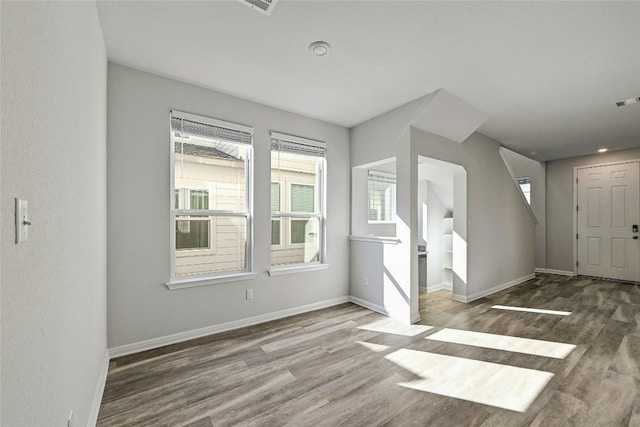 additional living space featuring hardwood / wood-style floors