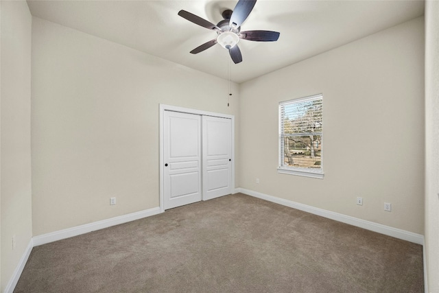 unfurnished bedroom featuring ceiling fan, carpet flooring, and a closet