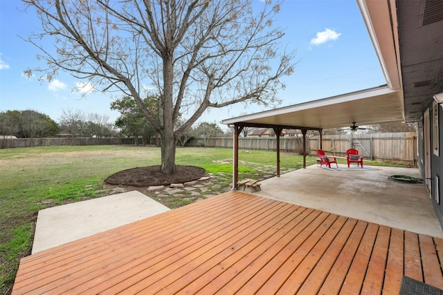 wooden deck featuring a lawn, ceiling fan, and a patio area