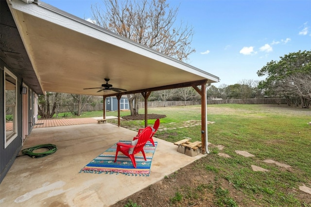 exterior space featuring ceiling fan and a shed