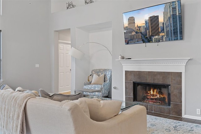 living room with a tiled fireplace