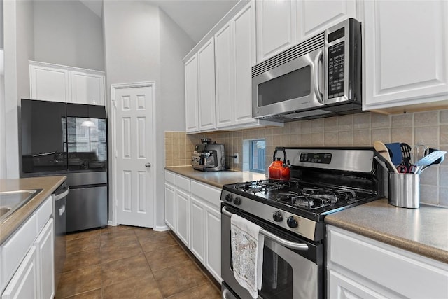 kitchen featuring backsplash, stainless steel appliances, and white cabinets