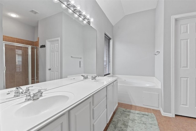 bathroom featuring vaulted ceiling, vanity, separate shower and tub, and tile patterned flooring