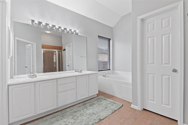 bathroom with vaulted ceiling, vanity, independent shower and bath, and tile patterned flooring