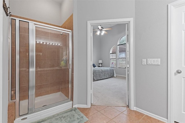 bathroom with a shower with shower door, tile patterned floors, and ceiling fan