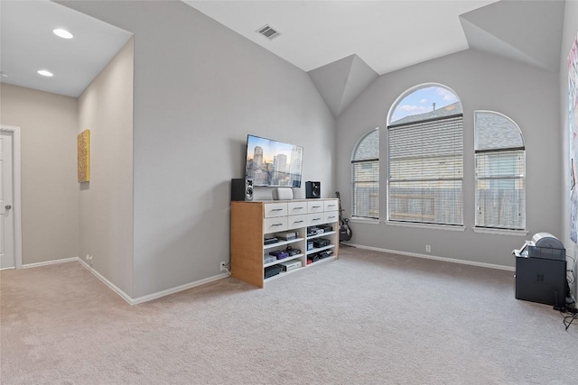 living area featuring light carpet and vaulted ceiling