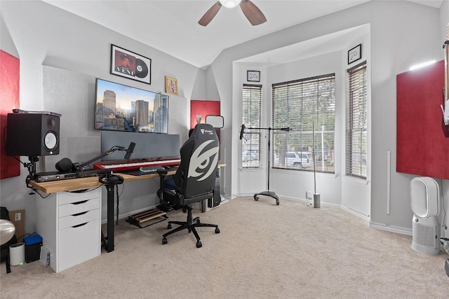 home office featuring ceiling fan, light colored carpet, and lofted ceiling