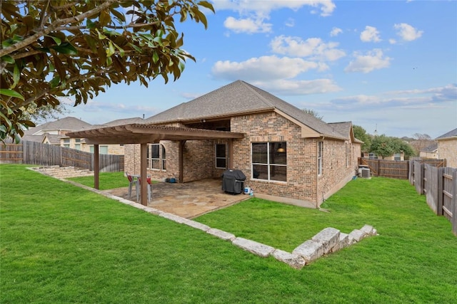 rear view of house with central AC, a patio area, and a lawn