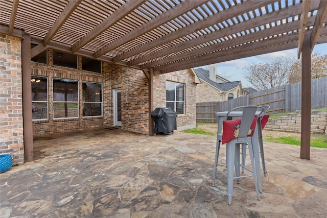 view of patio / terrace with area for grilling and a pergola