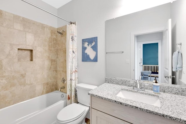 full bathroom with vanity, shower / tub combo, and toilet