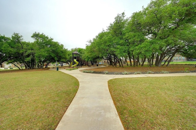 view of home's community featuring a lawn and a playground