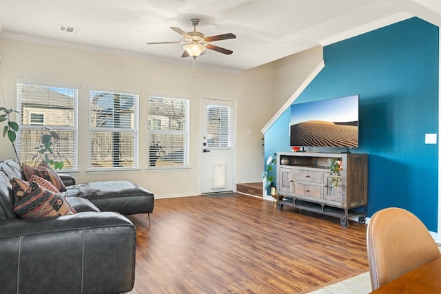 living room with hardwood / wood-style flooring, ornamental molding, and a wealth of natural light