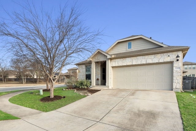 view of front of house with central AC unit and a garage