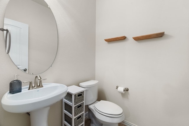 bathroom featuring toilet and sink