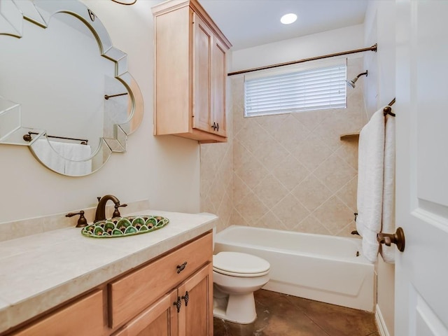 full bathroom featuring tiled shower / bath, vanity, toilet, and tile patterned flooring