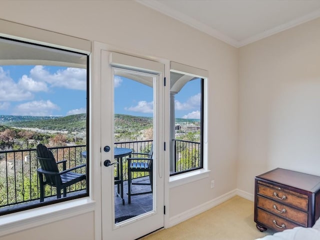 entryway featuring ornamental molding and light carpet