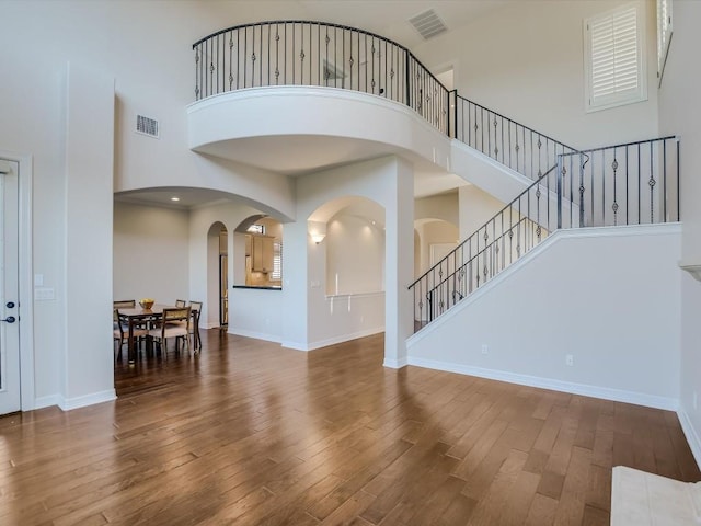 interior space featuring dark hardwood / wood-style flooring and a high ceiling