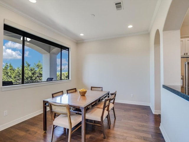 dining area with crown molding and dark hardwood / wood-style floors