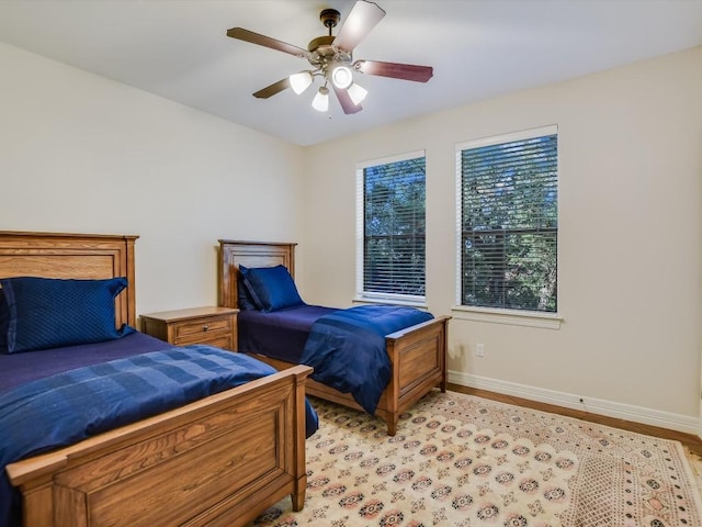 bedroom with light hardwood / wood-style flooring and ceiling fan