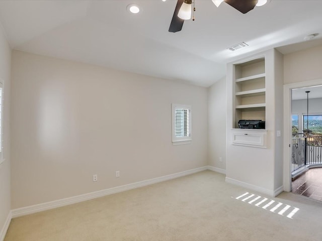 interior space featuring ceiling fan, lofted ceiling, and built in features