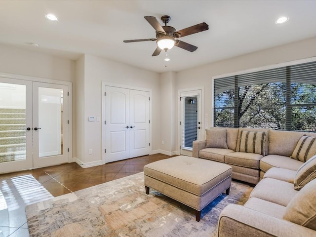 tiled living room featuring french doors and ceiling fan