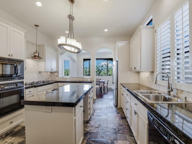 kitchen featuring white cabinetry, sink, black appliances, and a kitchen island