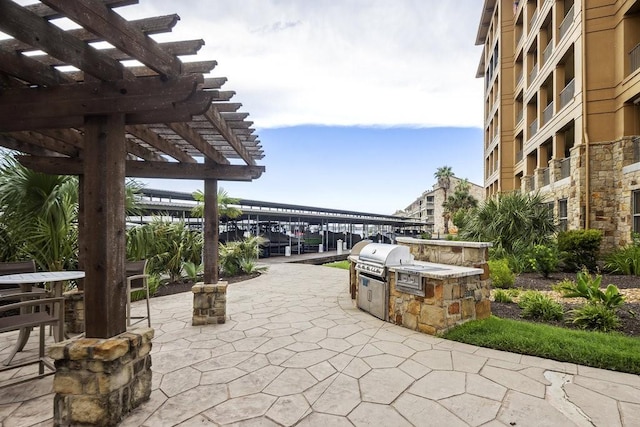 view of patio / terrace featuring area for grilling and a pergola