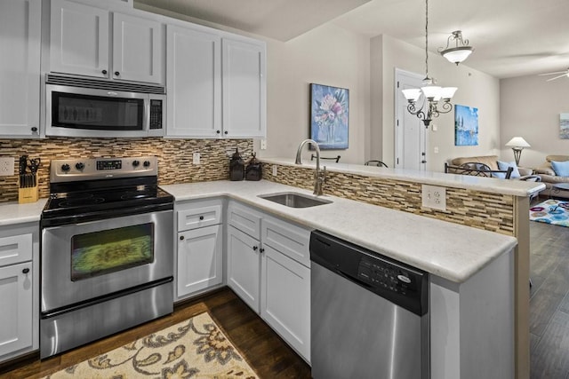 1001 The Cape Rd Unit 16, Horseshoe Bay, TX 78657 - kitchen featuring stainless steel appliances, a peninsula, open floor plan, and dark wood-style floors