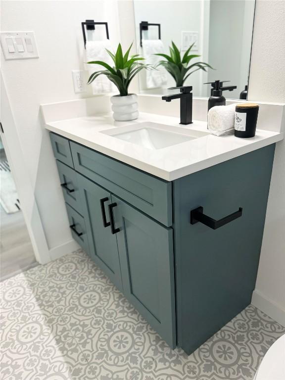 bathroom with tile patterned floors and vanity