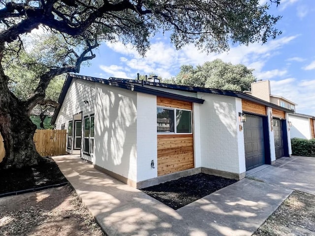 view of side of home featuring a garage