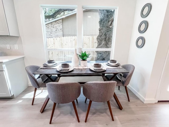 dining area with light hardwood / wood-style floors