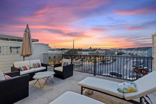 1005 Highknoll Ln, Georgetown, TX 78628 - patio terrace at dusk with an outdoor living space and a balcony