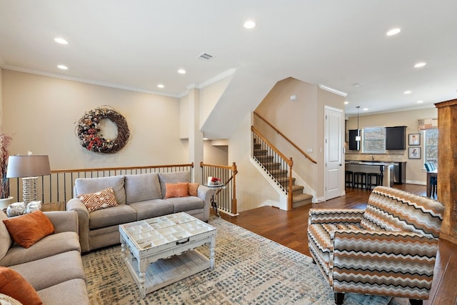 1005 Highknoll Ln, Georgetown, TX 78628 - living room featuring recessed lighting, dark wood-type flooring, crown molding, stairway, and baseboards