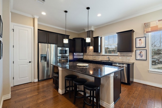 1005 Highknoll Ln, Georgetown, TX 78628 - kitchen with stainless steel appliances, backsplash, dark stone counters, a breakfast bar area, and dark wood finished floors