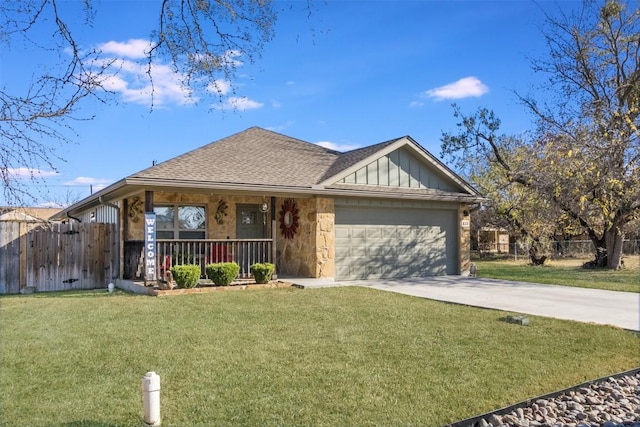 view of front of house featuring a porch, a garage, and a front lawn