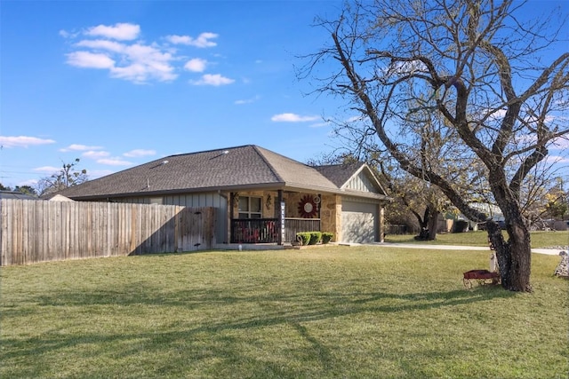 view of front facade featuring a garage, covered porch, and a front lawn