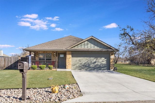 view of front of house featuring a garage, covered porch, and a front yard