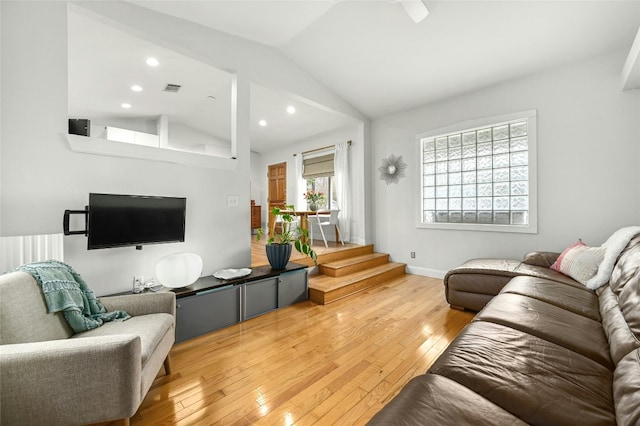 living room featuring lofted ceiling and hardwood / wood-style floors