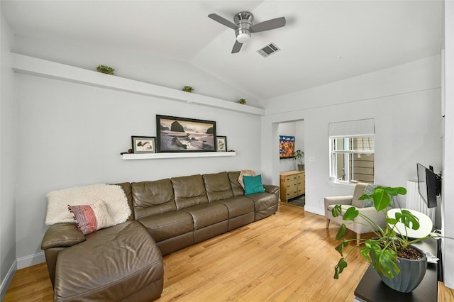 living room featuring hardwood / wood-style flooring, vaulted ceiling, and ceiling fan