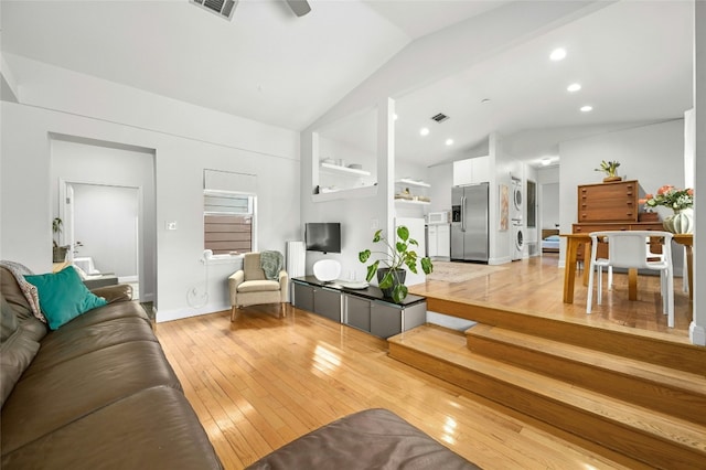 living room with lofted ceiling and light hardwood / wood-style flooring