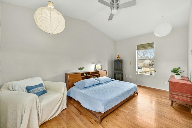 bedroom featuring vaulted ceiling, ceiling fan, and light hardwood / wood-style flooring