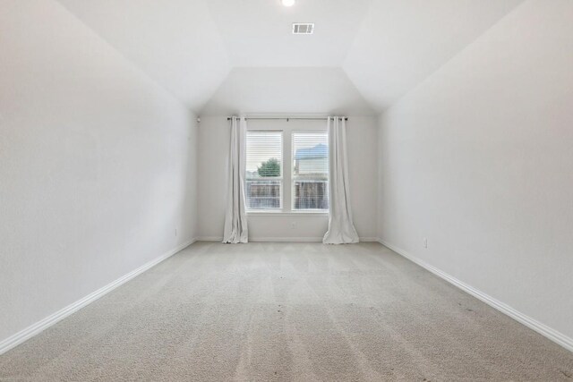 bonus room featuring vaulted ceiling and light carpet