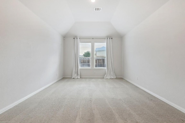 bonus room featuring lofted ceiling, carpet flooring, visible vents, and baseboards