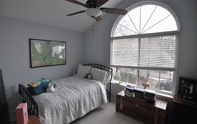 carpeted bedroom with ceiling fan and vaulted ceiling