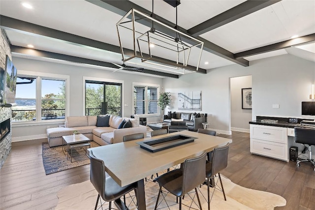 dining area with dark hardwood / wood-style floors and beamed ceiling