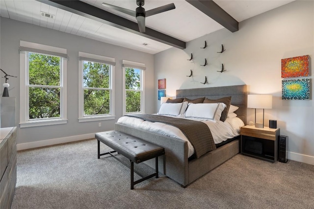 bedroom featuring beamed ceiling and light carpet