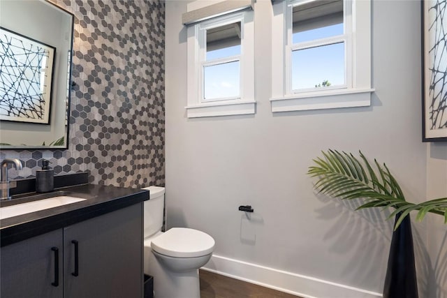 bathroom featuring hardwood / wood-style flooring, vanity, and toilet