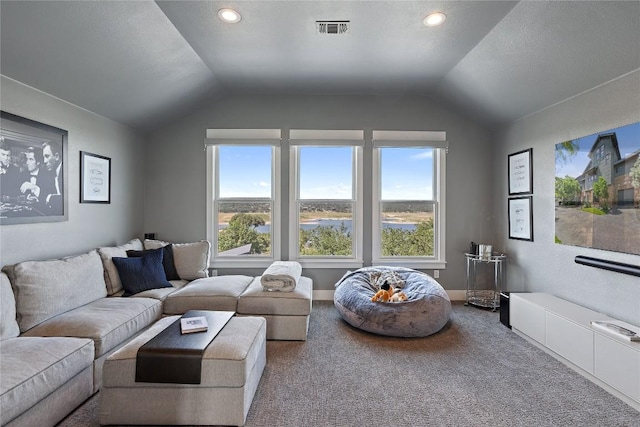 living room featuring lofted ceiling, a wealth of natural light, and carpet flooring