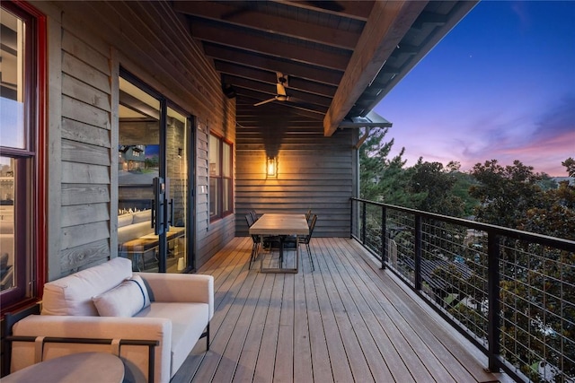 deck at dusk featuring outdoor lounge area