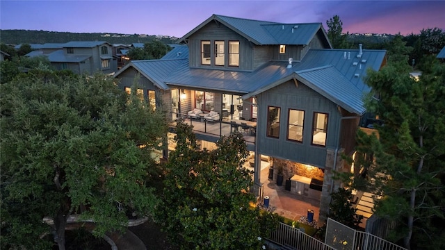 view of back house at dusk